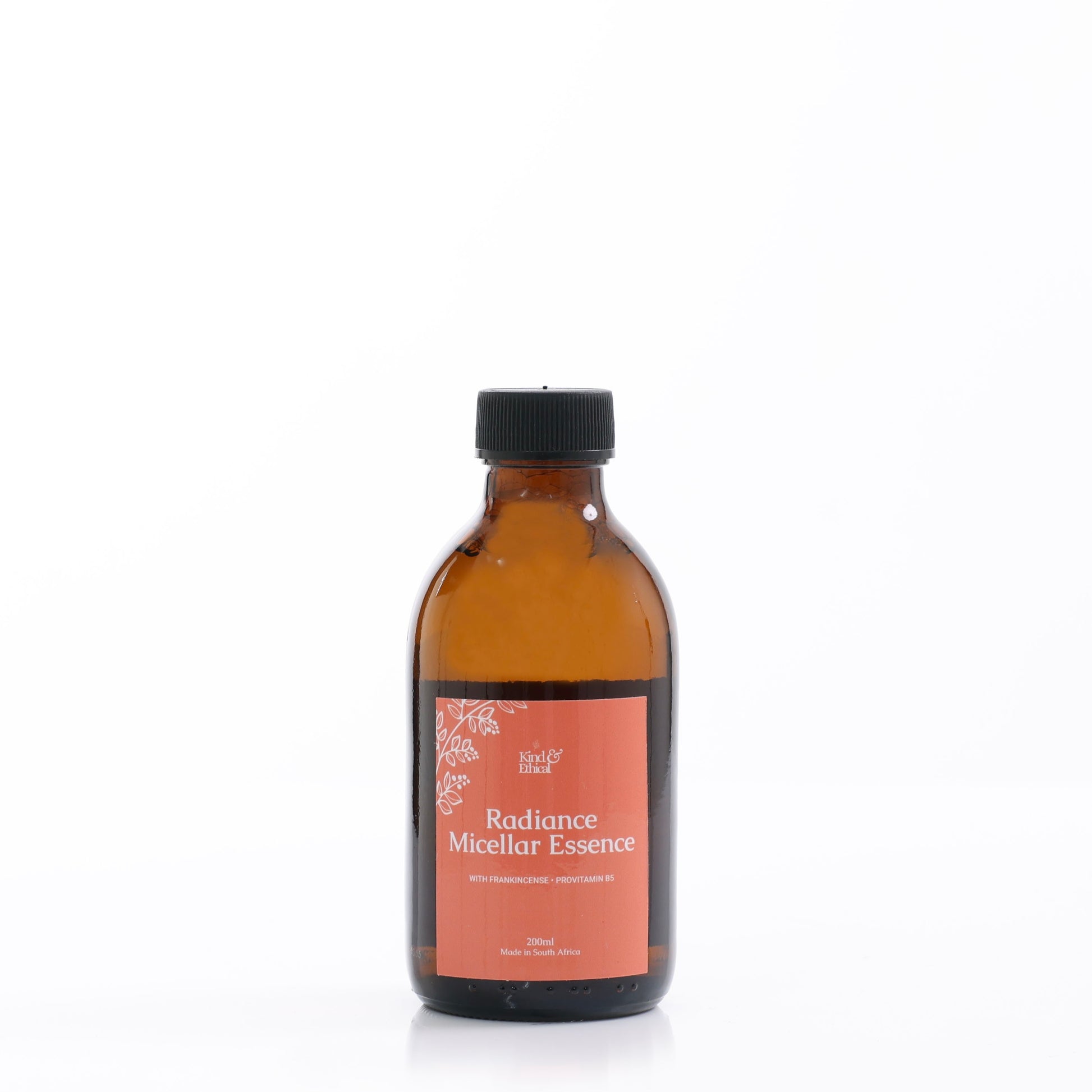 Amber glass bottle with a black cap labeled 'Radiance Micellar Essence' on a white background