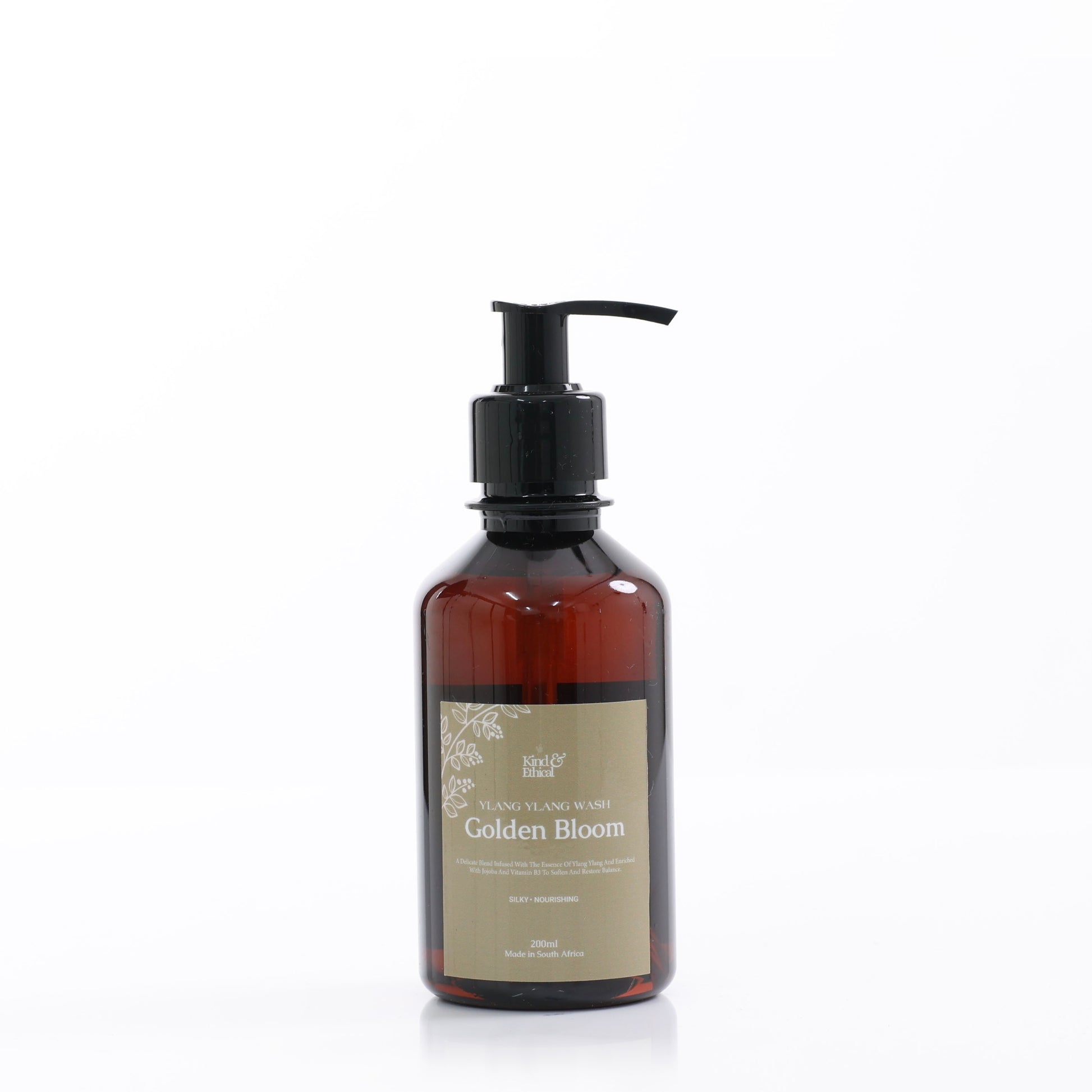 Brown bottle containing Ylang Ylang Body Wash with pump labeled 'Golden Bloom' on a white background